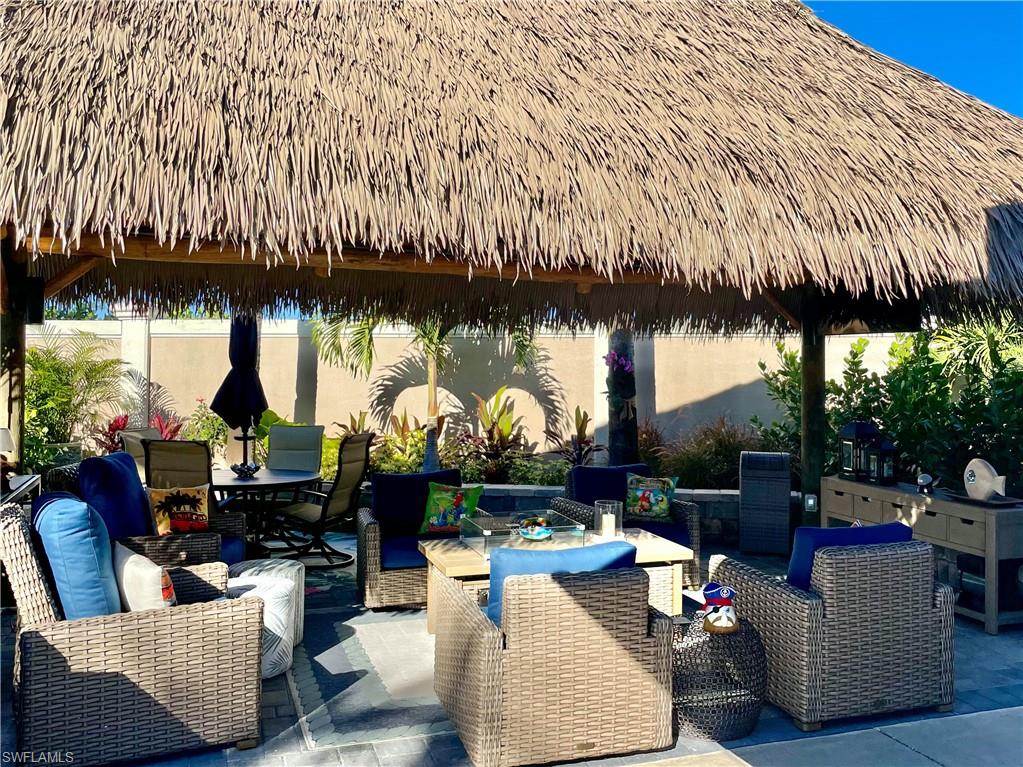 13627 Snook Circle Naples, FL 34114 - Photo 3 of 10 a living room with furniture and a floor to ceiling window