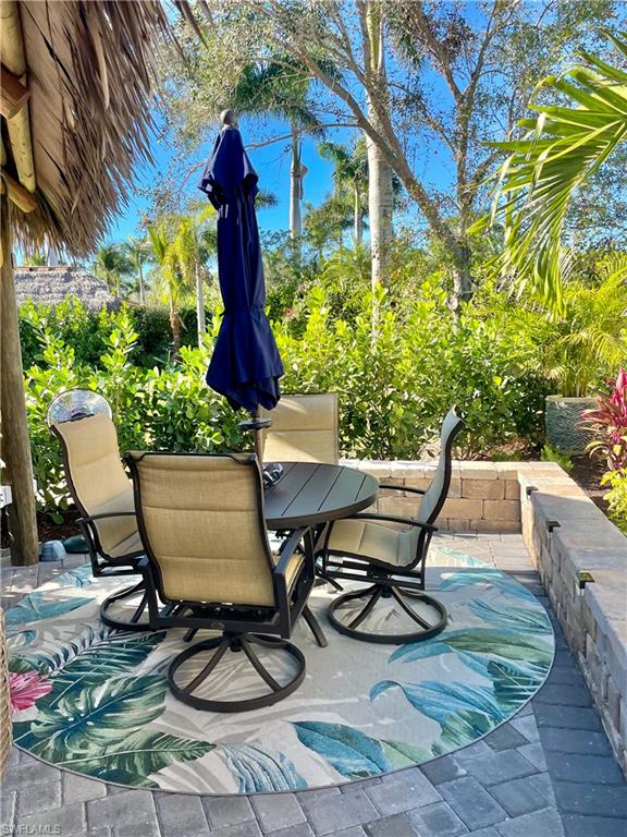 13627 Snook Circle Naples, FL 34114 - Photo 6 of 10 a view of a chairs and table in the patio