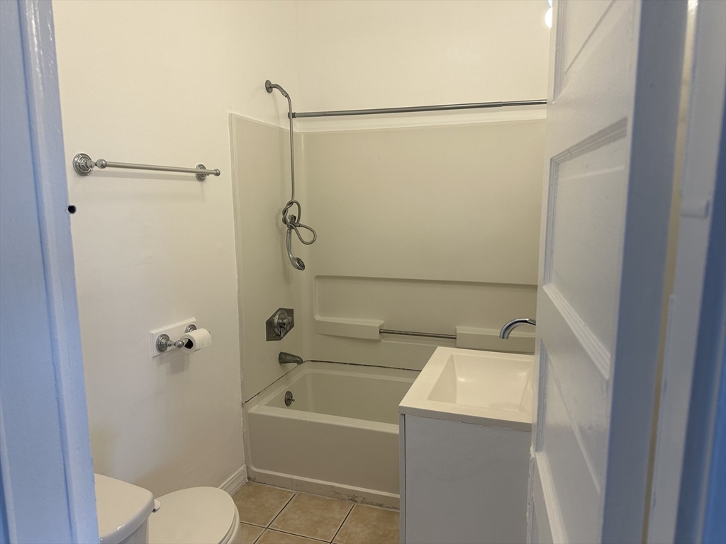 14 Hooper Street, Unit 3 Worcester, MA 01605 - Photo 12 of 12 a bathroom with a sink a toilet and shower