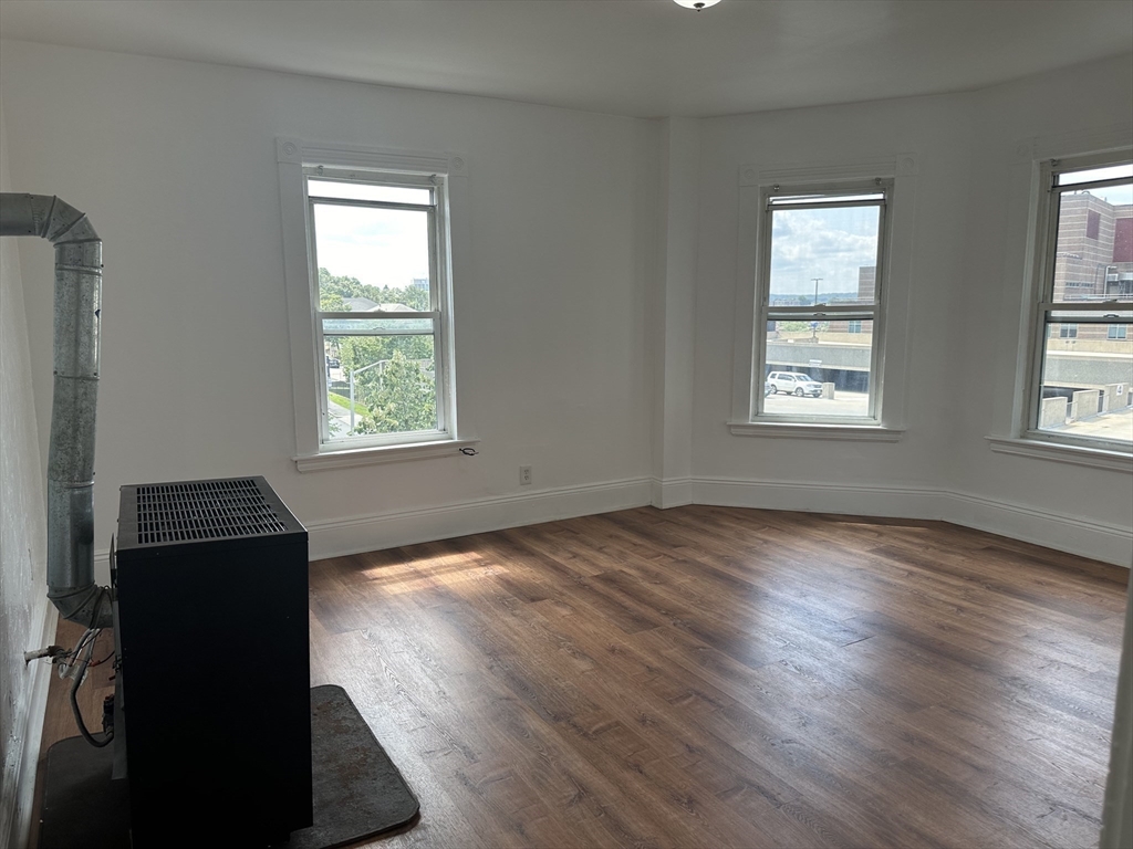 14 Hooper Street, Unit 3 Worcester, MA 01605 - Photo 2 of 12 a view of an empty room with wooden floor and a window