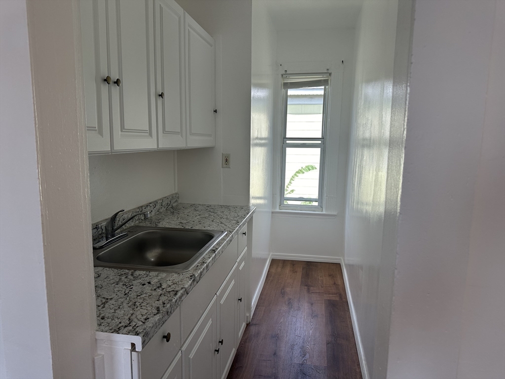14 Hooper Street, Unit 3 Worcester, MA 01605 - Photo 4 of 12 a kitchen with a sink and cabinets