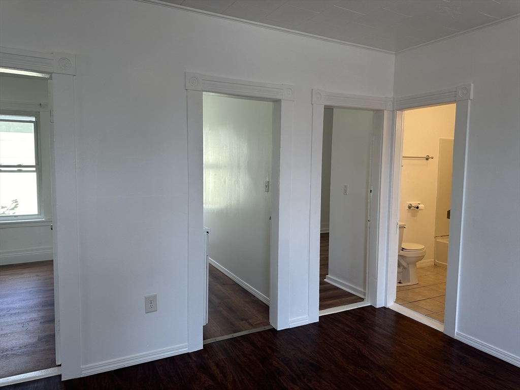 14 Hooper Street, Unit 3 Worcester, MA 01605 - Photo 5 of 12 an empty room with wooden floor closet and windows
