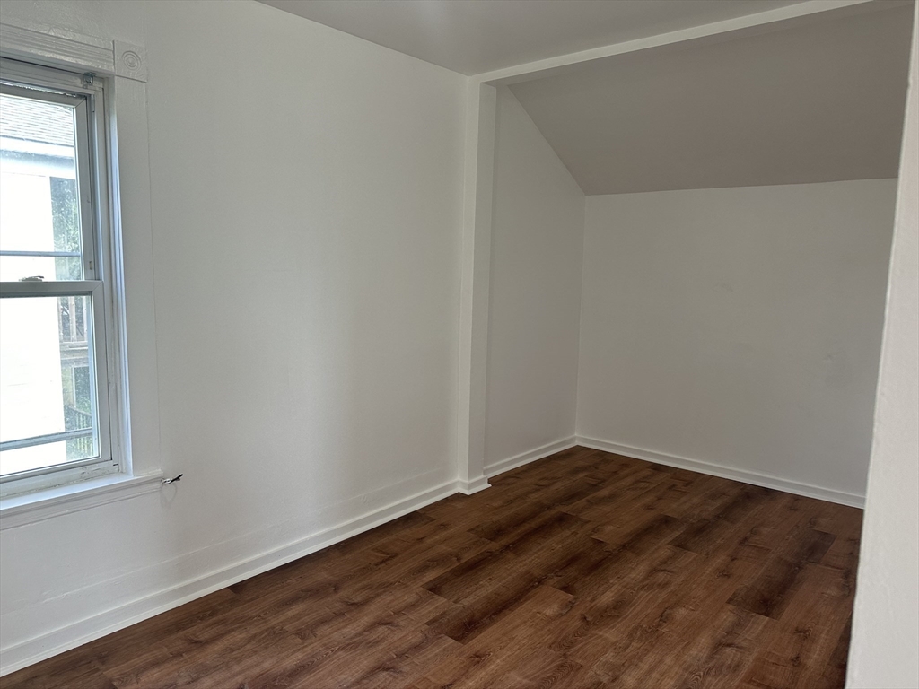 14 Hooper Street, Unit 3 Worcester, MA 01605 - Photo 6 of 12 an empty room with wooden floor and windows