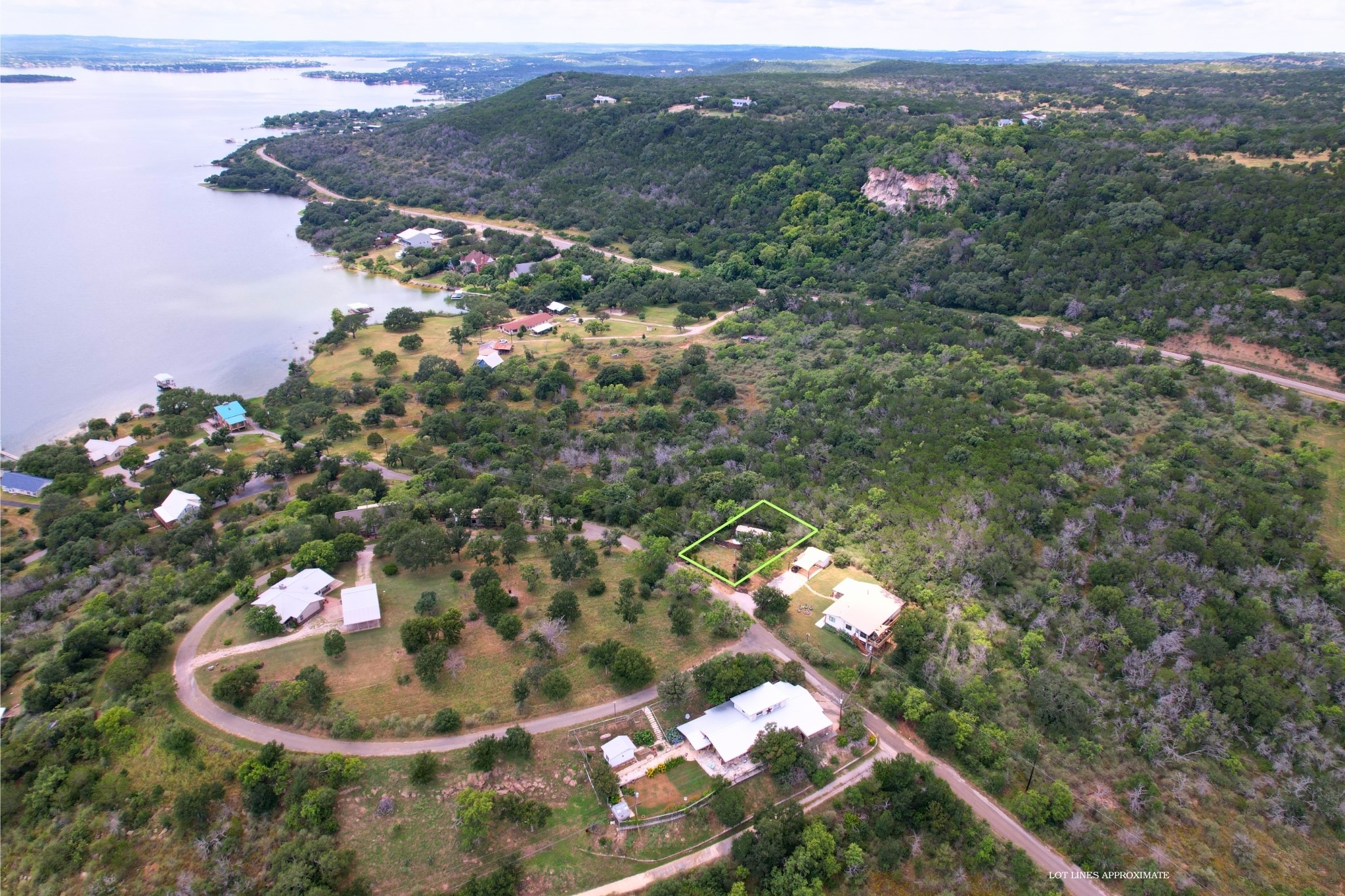 706 Cr138a Road Burnet, TX 78611 - Photo 3 of 18 A tranquil aerial perspective reveals a secluded lakeside community nestled amidst lush, verdant hills.