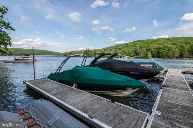 a view of swimming pool with a patio and fire pit