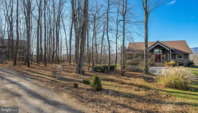 a view of a dry field with mountains in the background