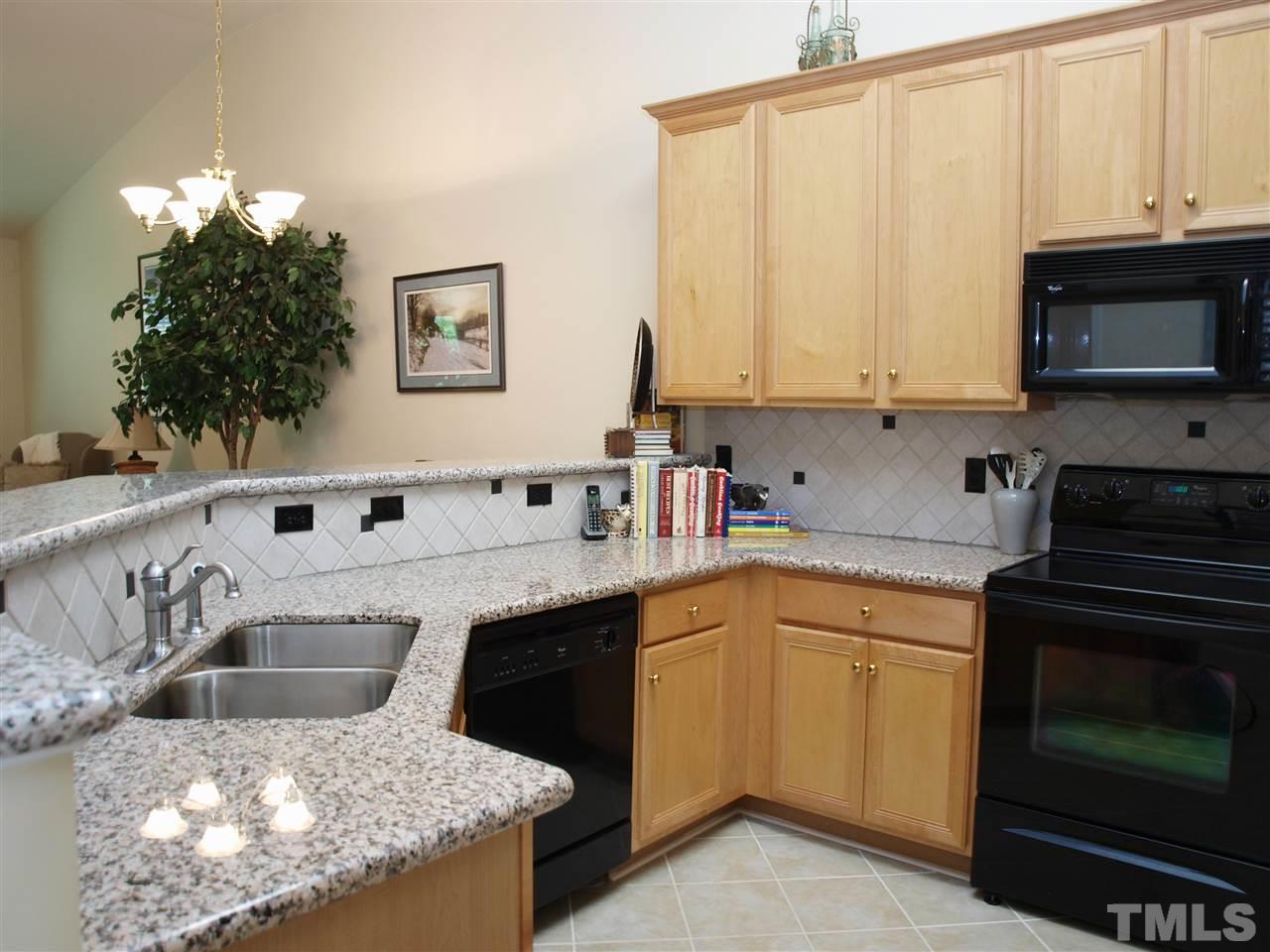 10465 Dapping Drive Raleigh, NC 27614 - Photo 2 of 19 a kitchen with a sink stove and microwave