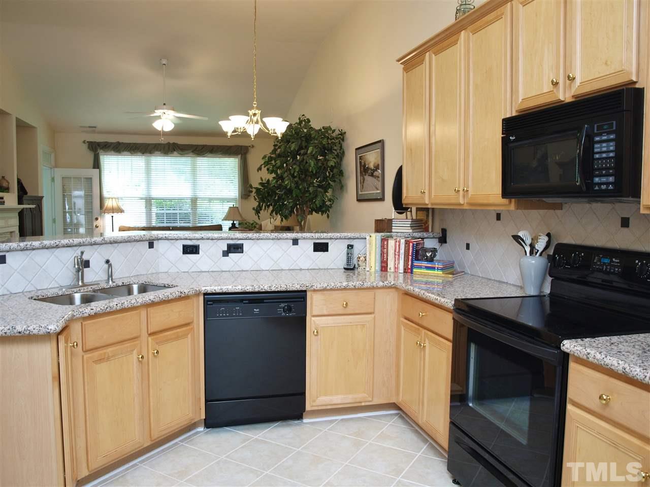 10465 Dapping Drive Raleigh, NC 27614 - Photo 3 of 19 a kitchen with a sink stove and microwave