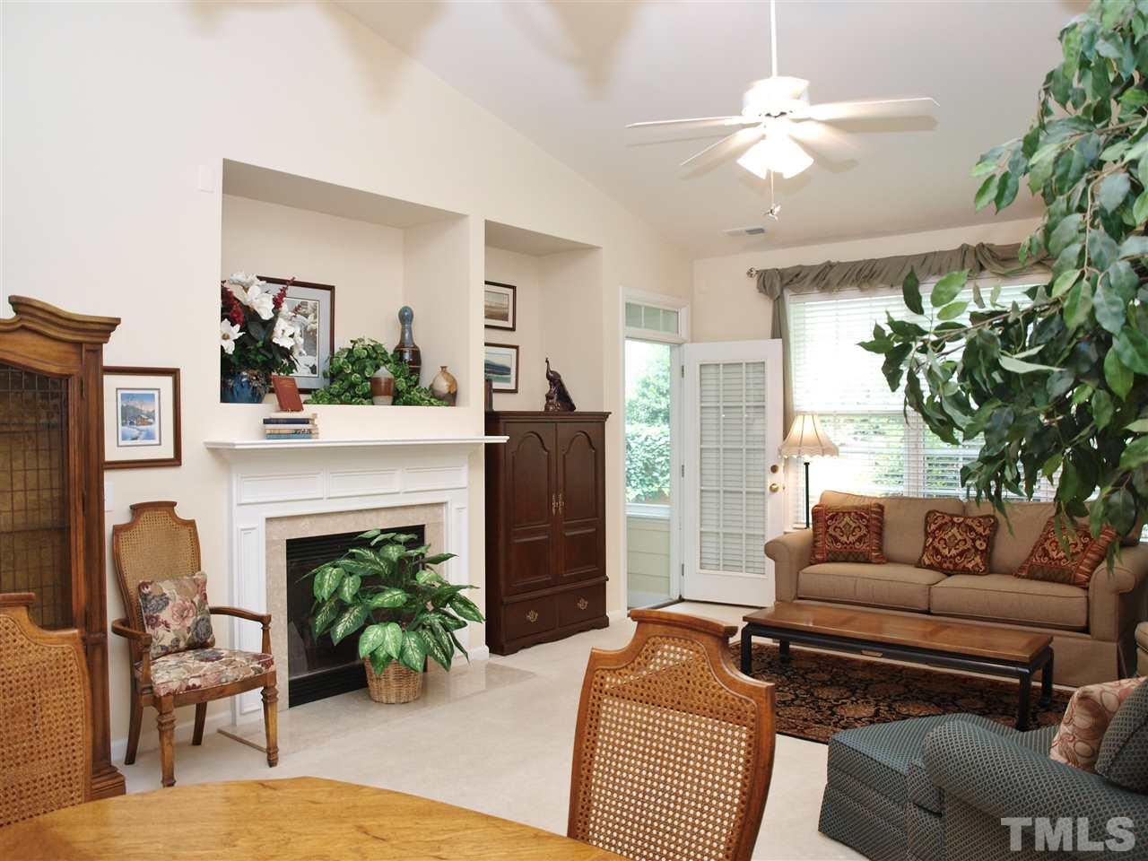 10465 Dapping Drive Raleigh, NC 27614 - Photo 4 of 19 a living room with furniture a potted plant and a fireplace