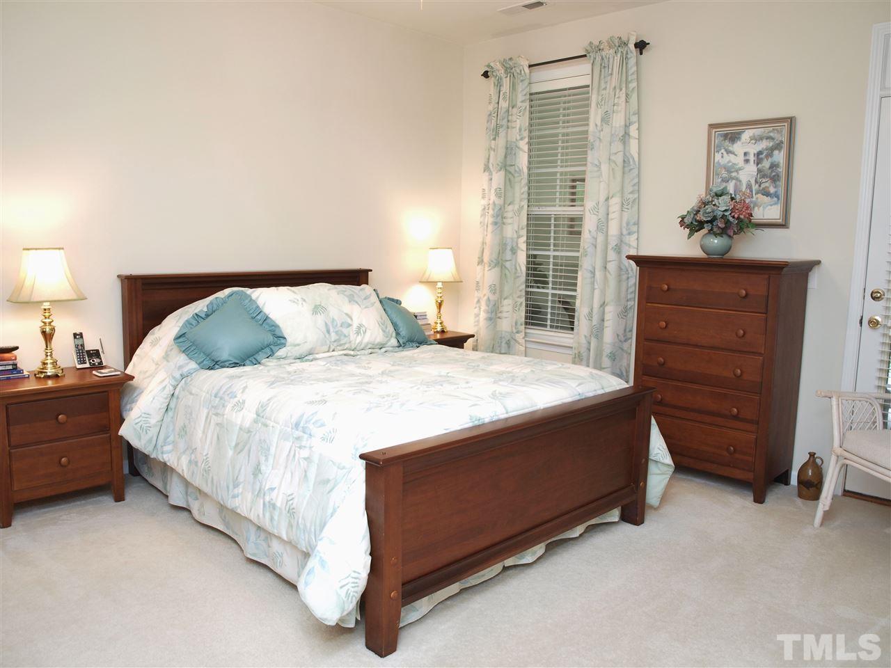 10465 Dapping Drive Raleigh, NC 27614 - Photo 7 of 19 a bed sitting in a bedroom next to a window