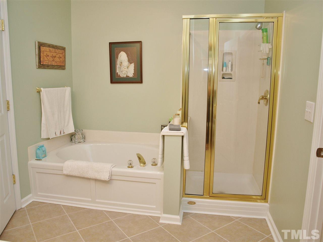 10465 Dapping Drive Raleigh, NC 27614 - Photo 9 of 19 a bathroom with a bathtub and a shower