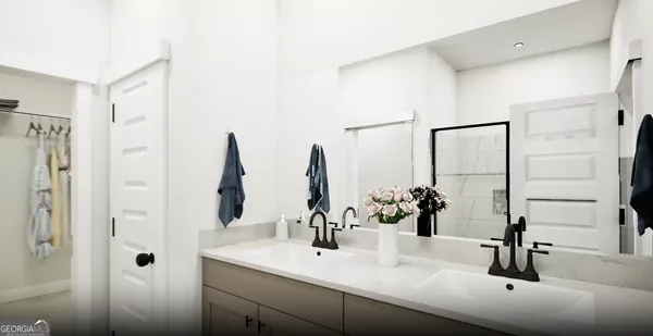 a bathroom with double vanity sinks and a mirror
