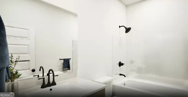 a bathroom with a tub sink and mirror