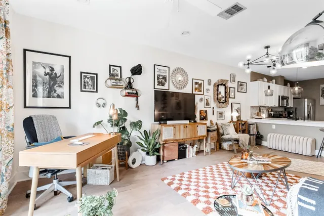 a view of a livingroom with furniture and a flat screen tv