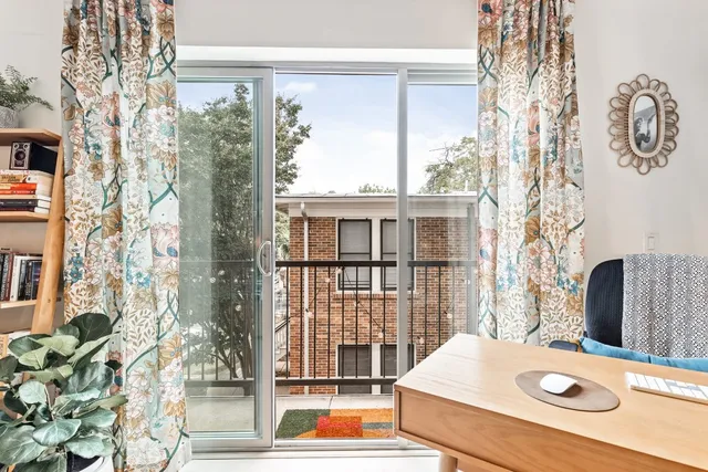 a view of a balcony with chair and table