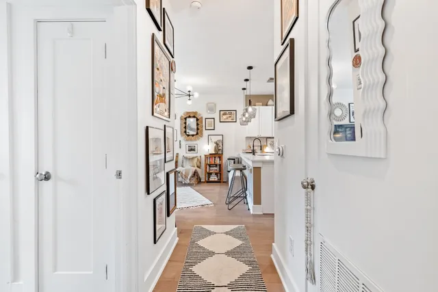 a view of a hallway to a livingroom and dinning room
