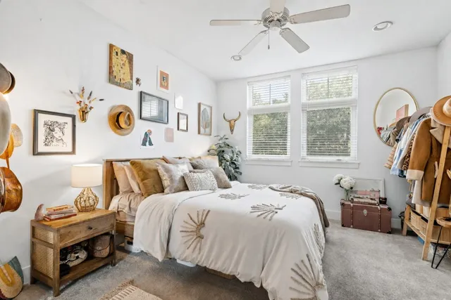 a bedroom with bed and a chandelier