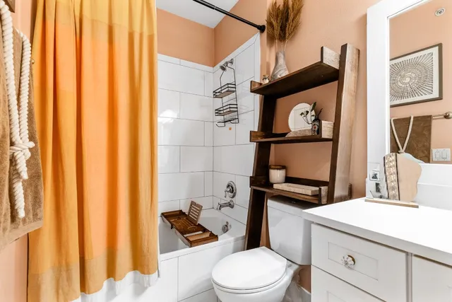 a bathroom with a toilet sink and vanity