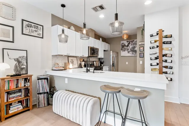a large kitchen with cabinets and a wooden floor