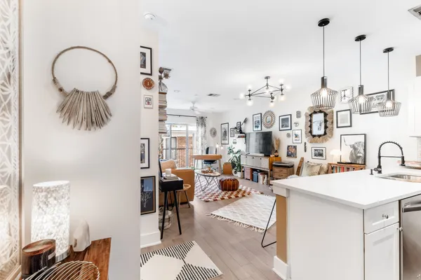 a living room with lots of furniture and a chandelier