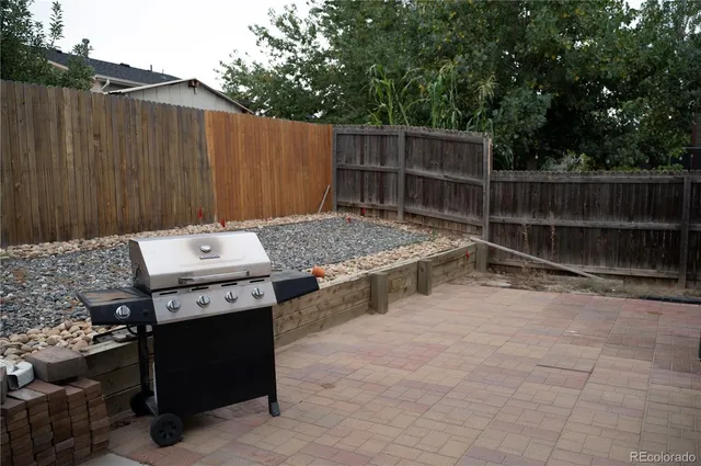 a backyard of a house with table and chairs