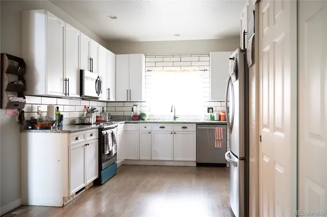 a kitchen with a sink stove and cabinets