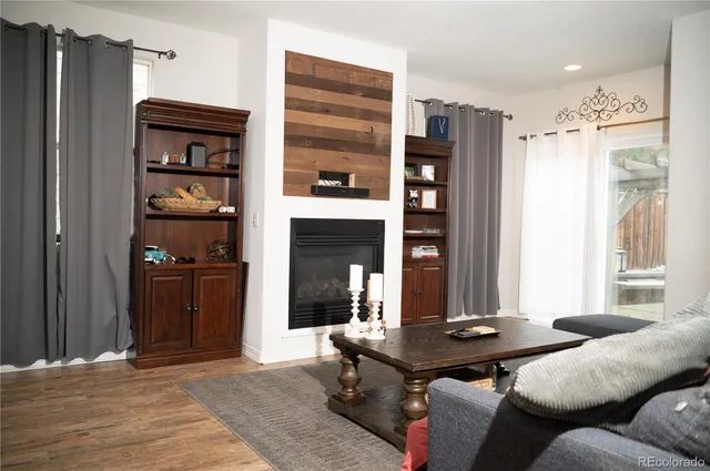 a living room with furniture a window and a fireplace