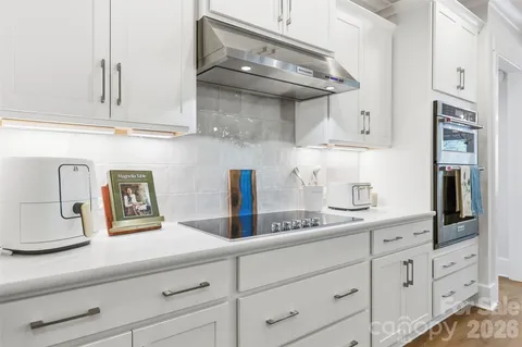 a kitchen with cabinets and stainless steel appliances