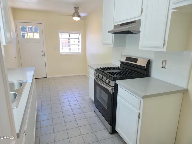 a kitchen that has a sink and a stove