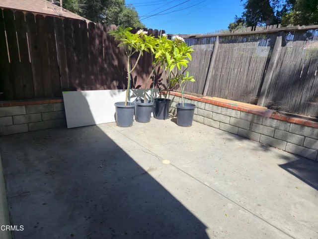 a view of a flower pot with wooden fence