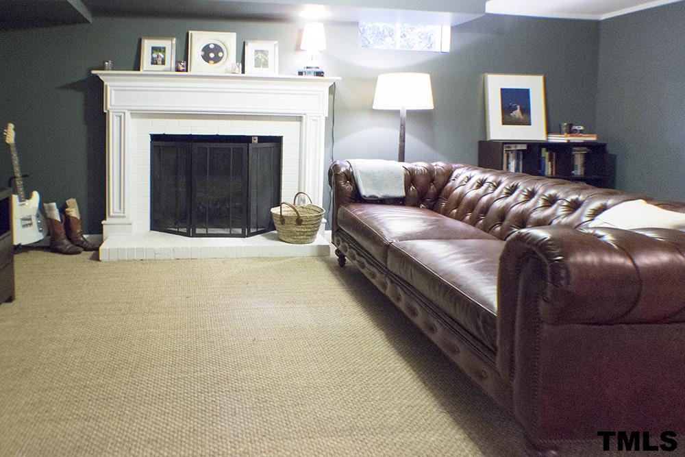 2216 Alexander Road Raleigh, NC 27608 - Photo 22 of 24 a living room with furniture and a fireplace