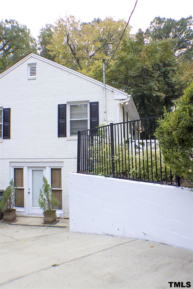 2216 Alexander Road Raleigh, NC 27608 - Photo 24 of 24 a side view of a house with a yard