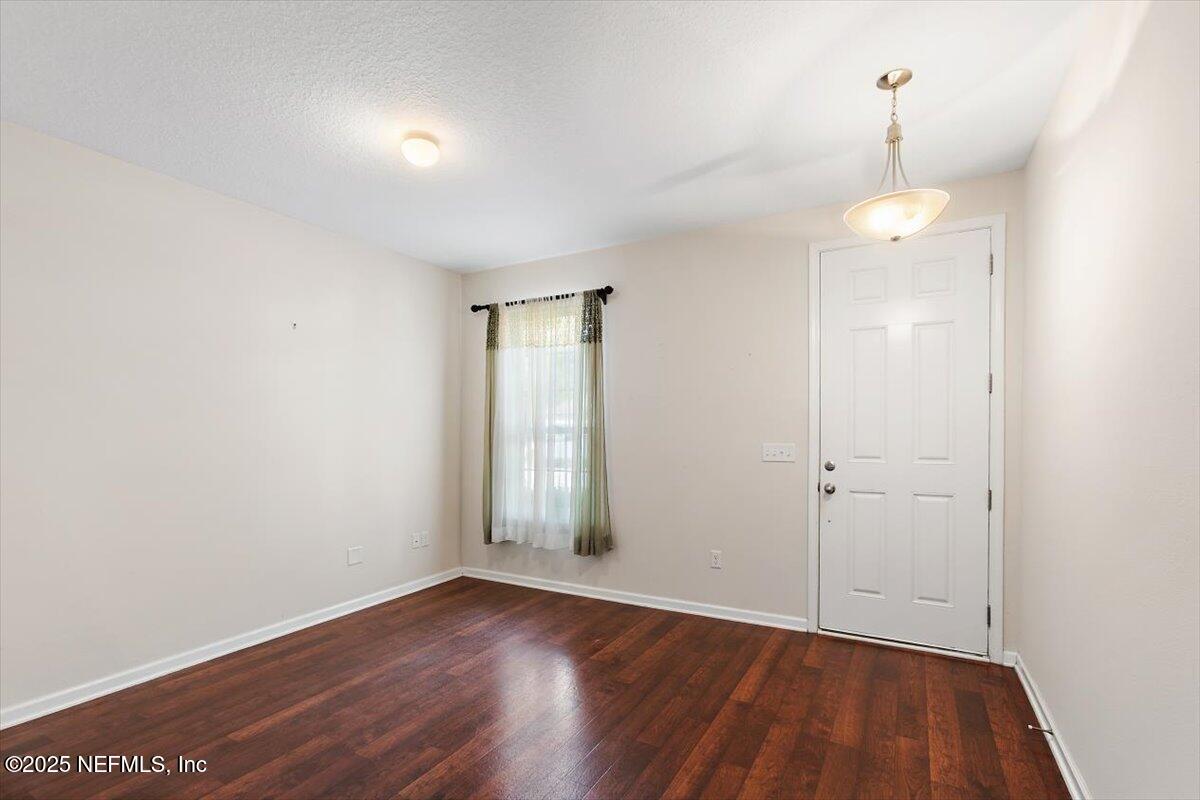 38 Litke Lane St. Augustine, FL 32086 - Photo 17 of 27 an empty room with wooden floor and windows