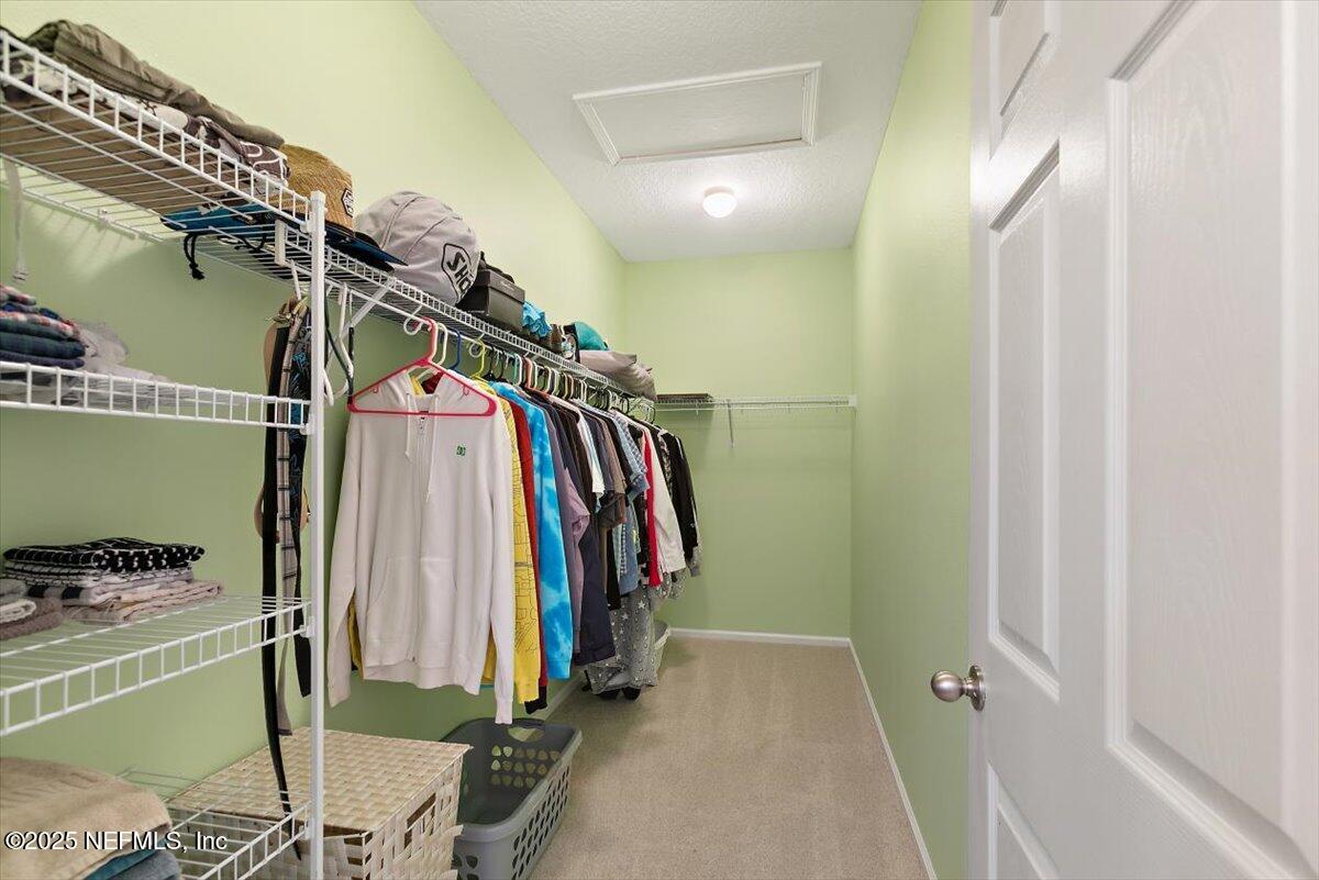 38 Litke Lane St. Augustine, FL 32086 - Photo 7 of 27 a view of walk in closet with clothes and shoes
