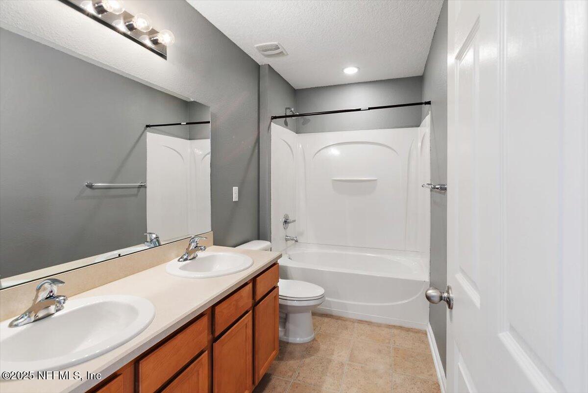 38 Litke Lane St. Augustine, FL 32086 - Photo 9 of 27 a bathroom with a sink a toilet and shower