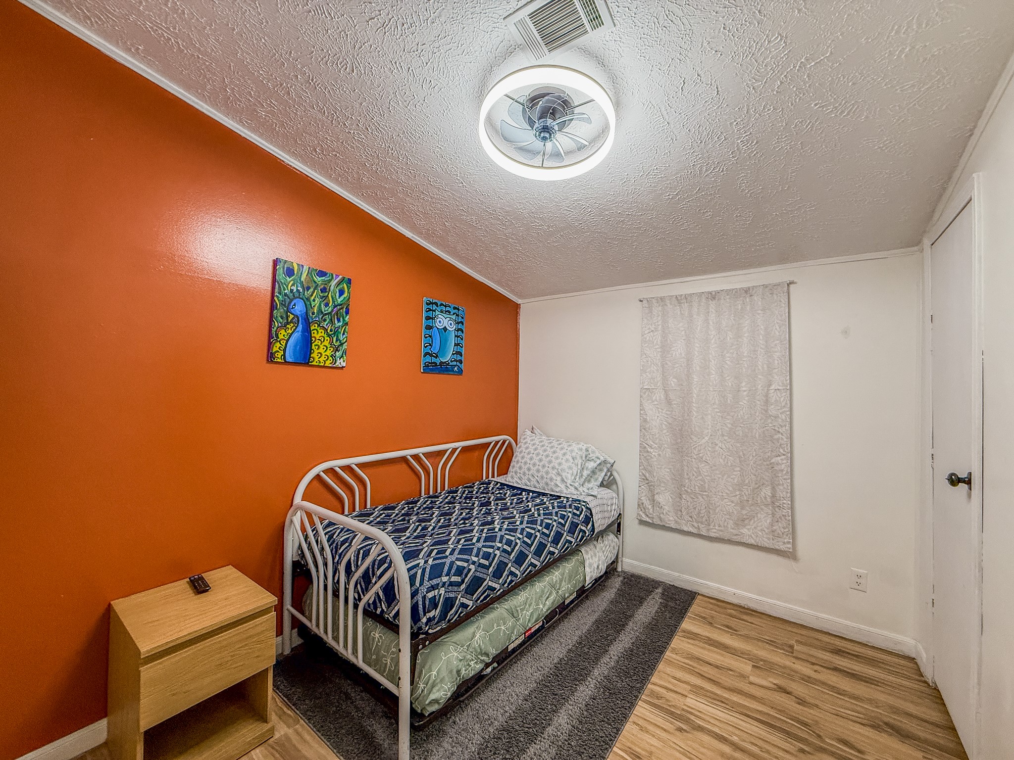 2015 Holly Street Austin, TX 78702 - Photo 17 of 24 A well-lit room featuring durable flooring, perfect for rest and relaxation.