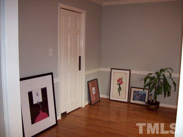 5904 Stable Court Raleigh, NC 27612 - Photo 5 of 16 a view of a hallway with wooden floor and stairs