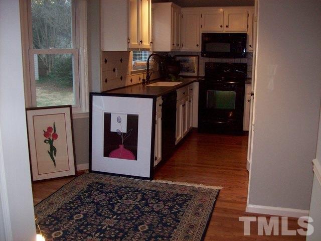5904 Stable Court Raleigh, NC 27612 - Photo 6 of 16 a kitchen with stainless steel appliances granite countertop a refrigerator stove and sink