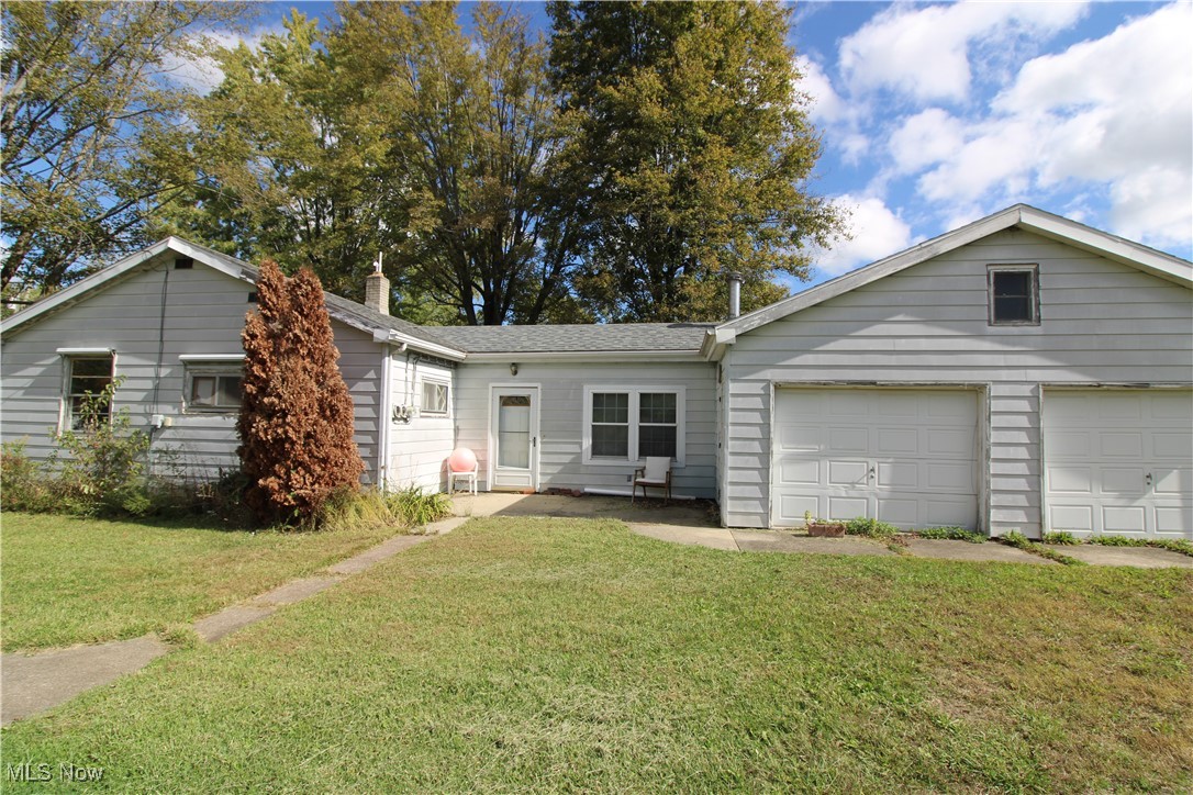 5084 West Fremont Road Port Clinton, OH 43452 - Photo 1 of 19 Ranch-style house featuring a front lawn, a chimney, an attached garage, and a shingled roof
