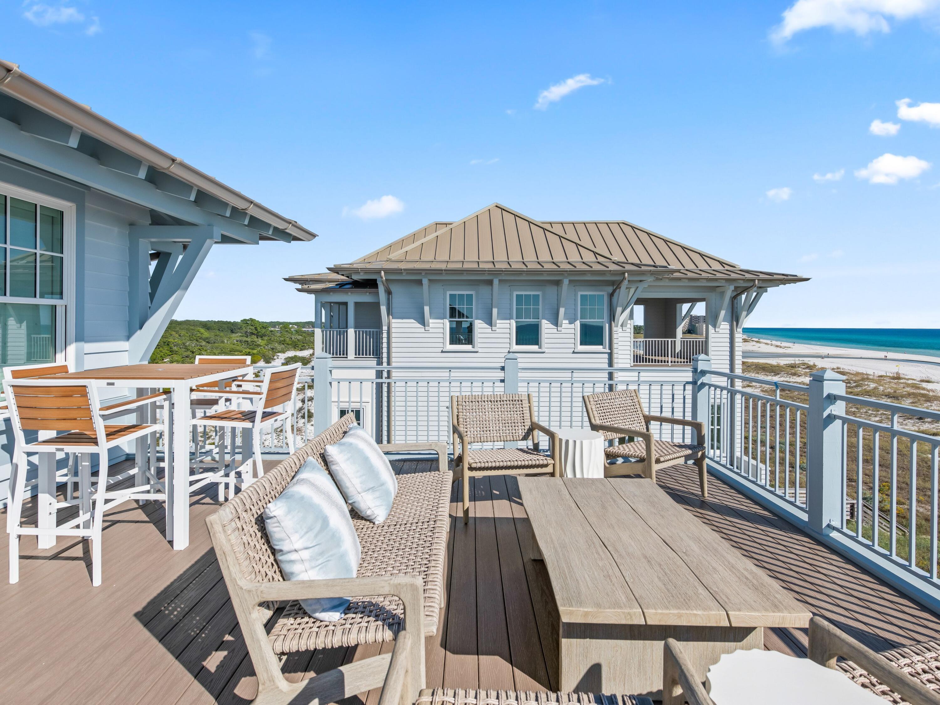 Lot 19 West Lupin Beach Dr Inlet Beach Inlet Beach, FL 32461 - Photo 54 of 57 a view of a patio with table and chairs potted plants with wooden floor