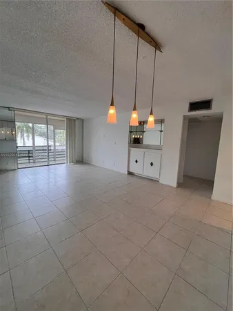 a room with natural light and kitchen appliances