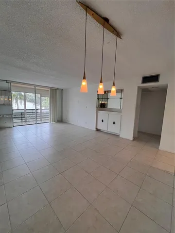 a room with natural light and kitchen appliances