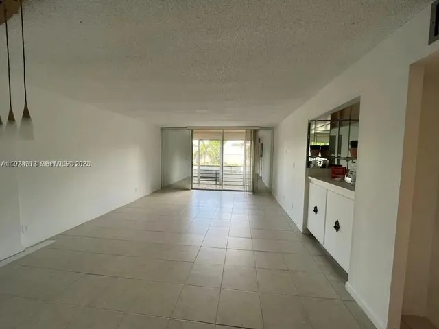 a hallway with window and chandelier