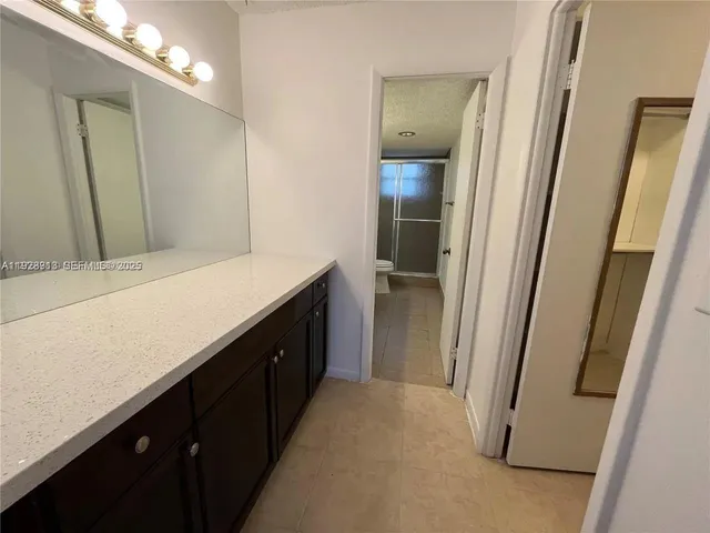 a kitchen with a sink and a mirror