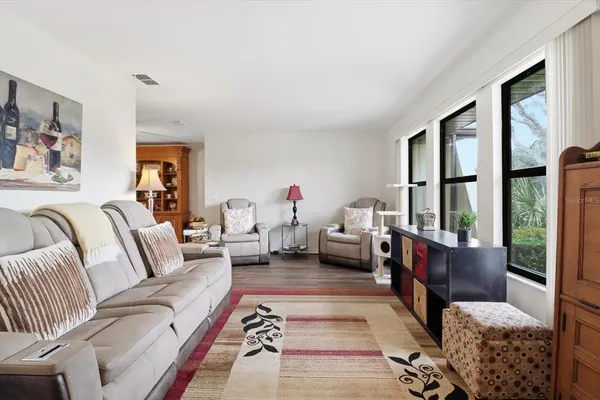 a living room with furniture large window and couch
