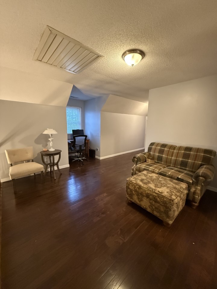 405 Robins Street Lawrenceburg, TN 38464 - Photo 37 of 65 a living room with furniture and a lamp