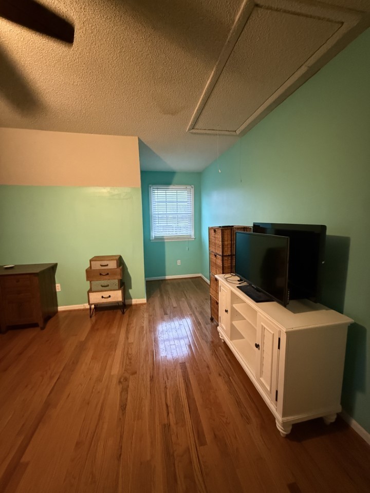 405 Robins Street Lawrenceburg, TN 38464 - Photo 38 of 65 a living room with furniture and a flat screen tv