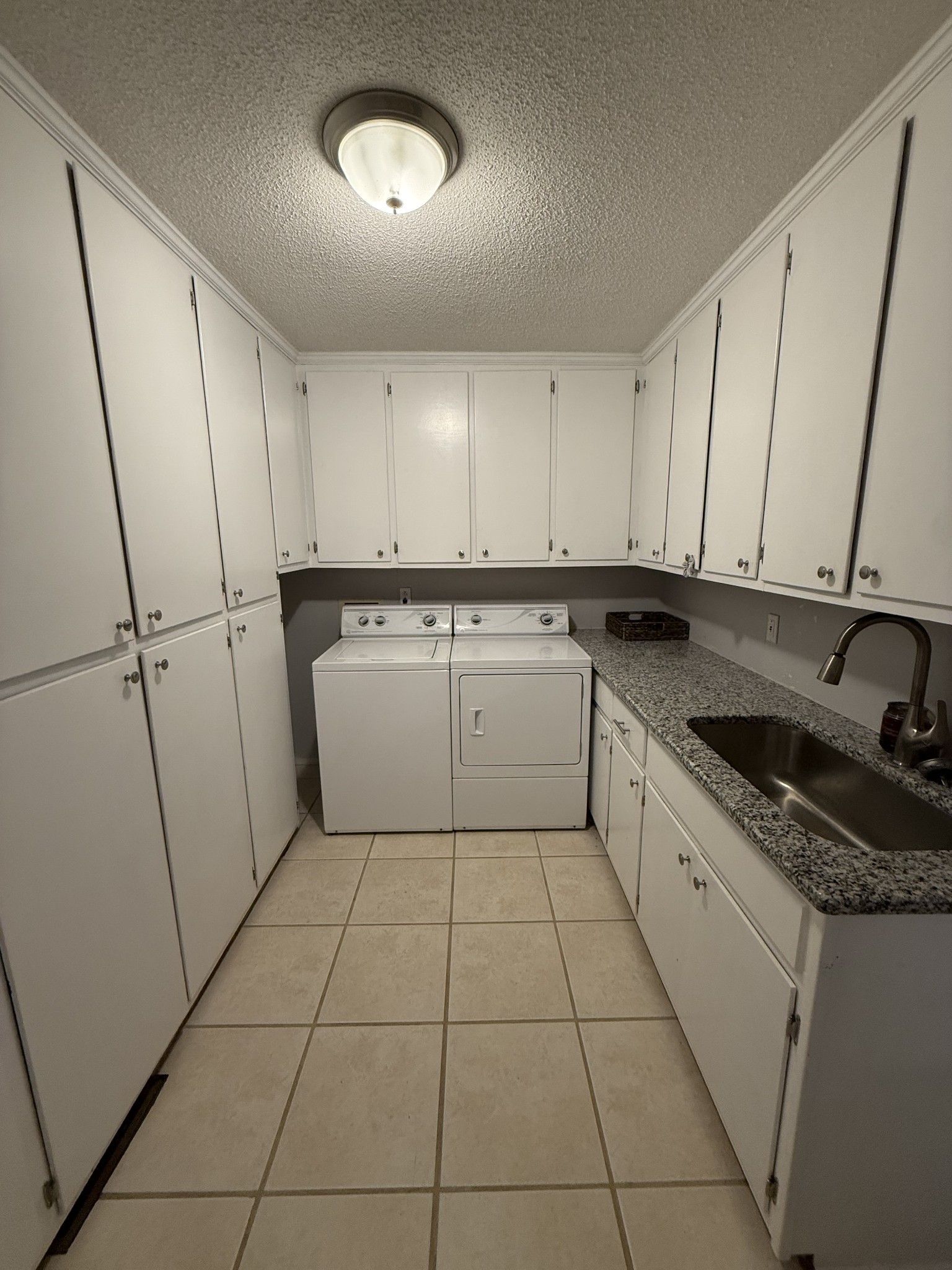 405 Robins Street Lawrenceburg, TN 38464 - Photo 59 of 65 a kitchen with a sink a stove top oven and cabinets