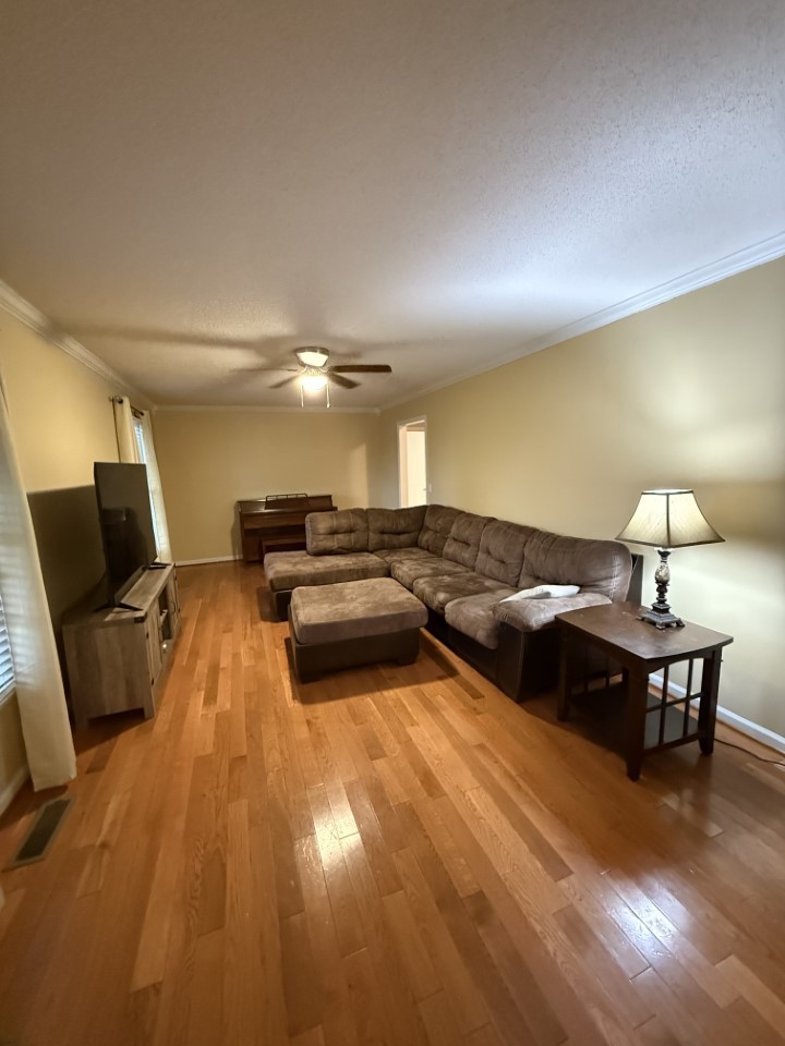 405 Robins Street Lawrenceburg, TN 38464 - Photo 7 of 65 a living room with furniture and a flat screen tv