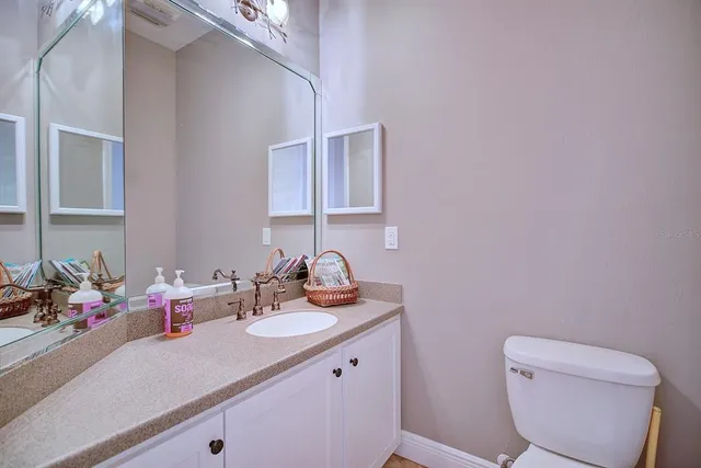 a bathroom with a toilet sink and mirror